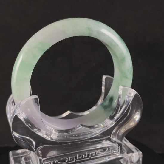 A soft lavender with green swirl jadeite bangle.