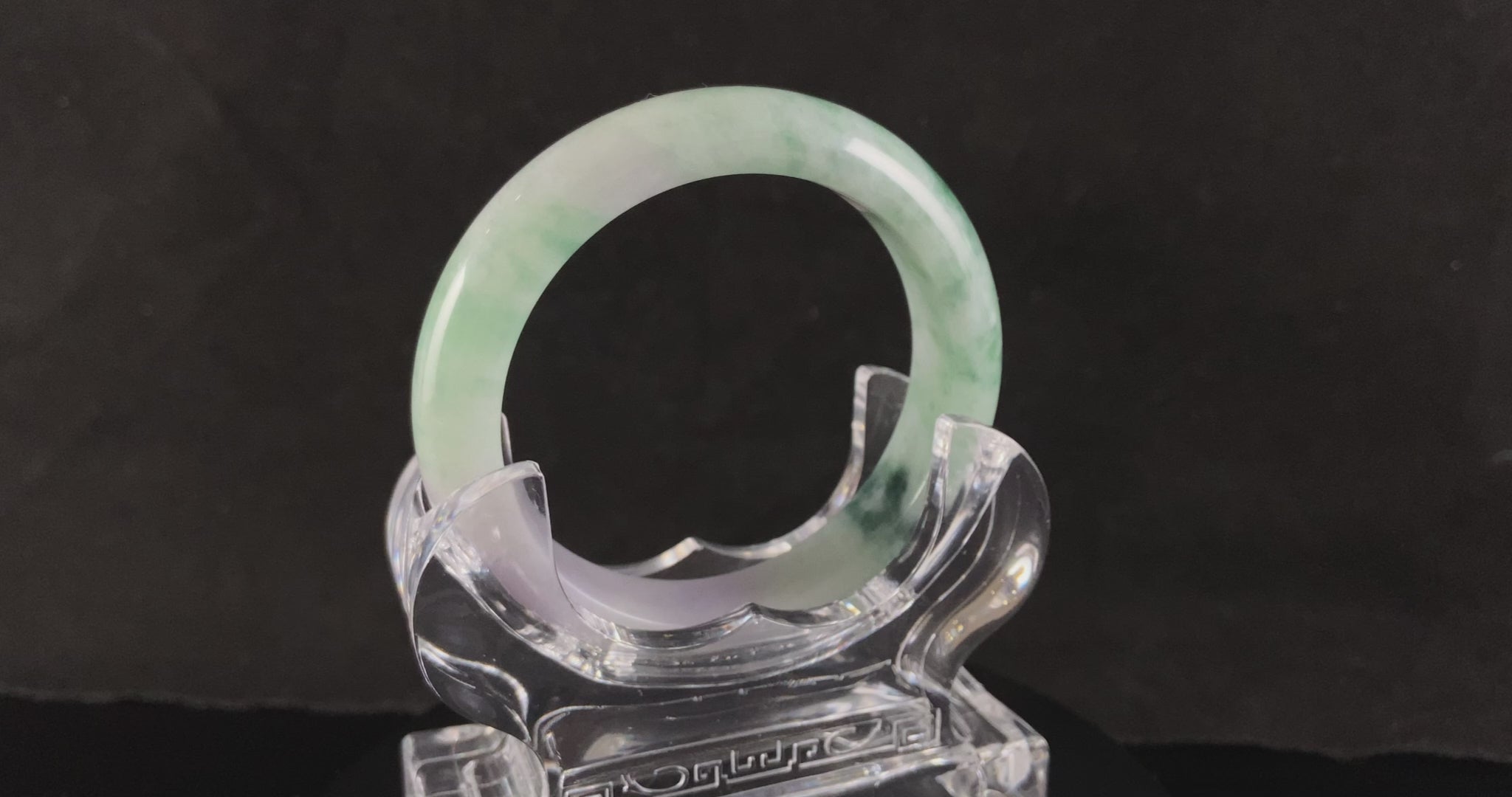 A soft lavender with green swirl jadeite bangle.