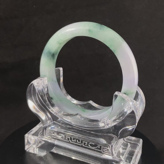A lilac cloud with floating green jadeite bangle.