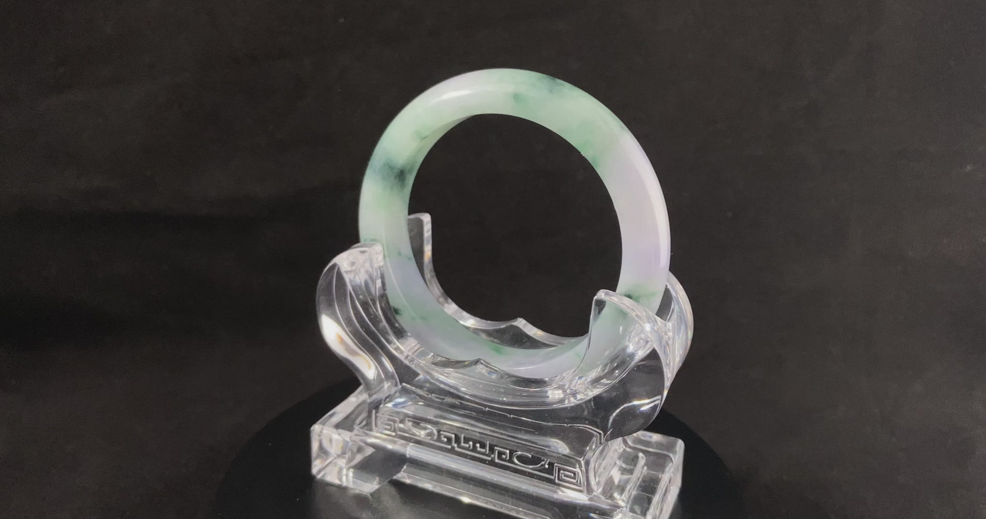 A lilac cloud with floating green jadeite bangle.