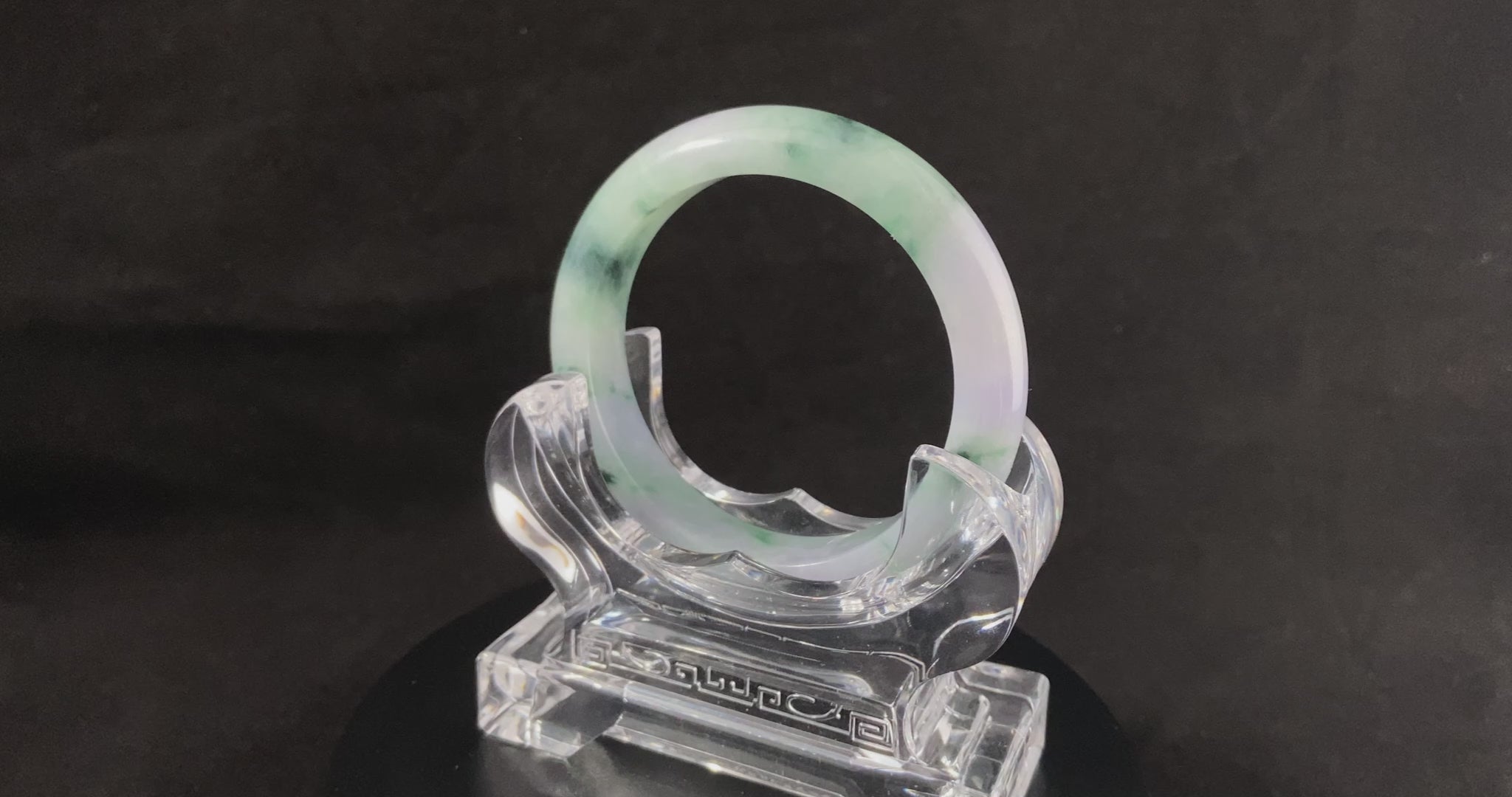 A lilac cloud with floating green jadeite bangle.