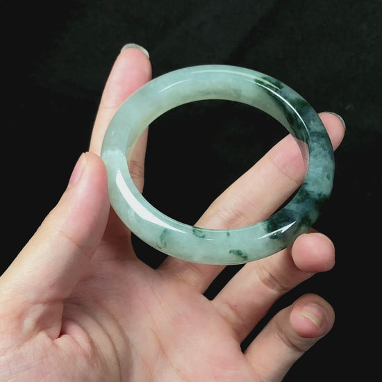 A moss green icy bloom jadeite bangle.