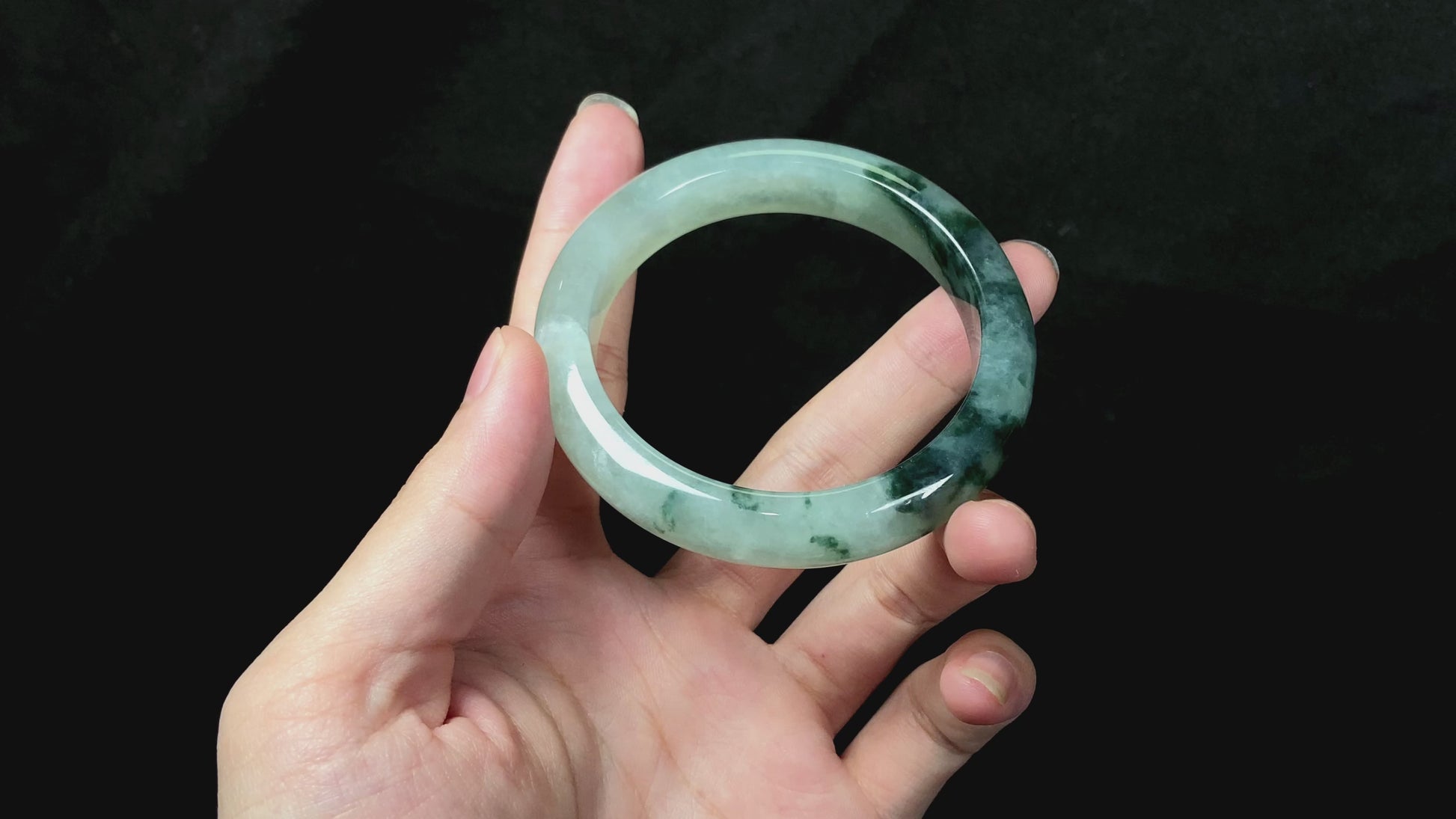 A moss green icy bloom jadeite bangle.