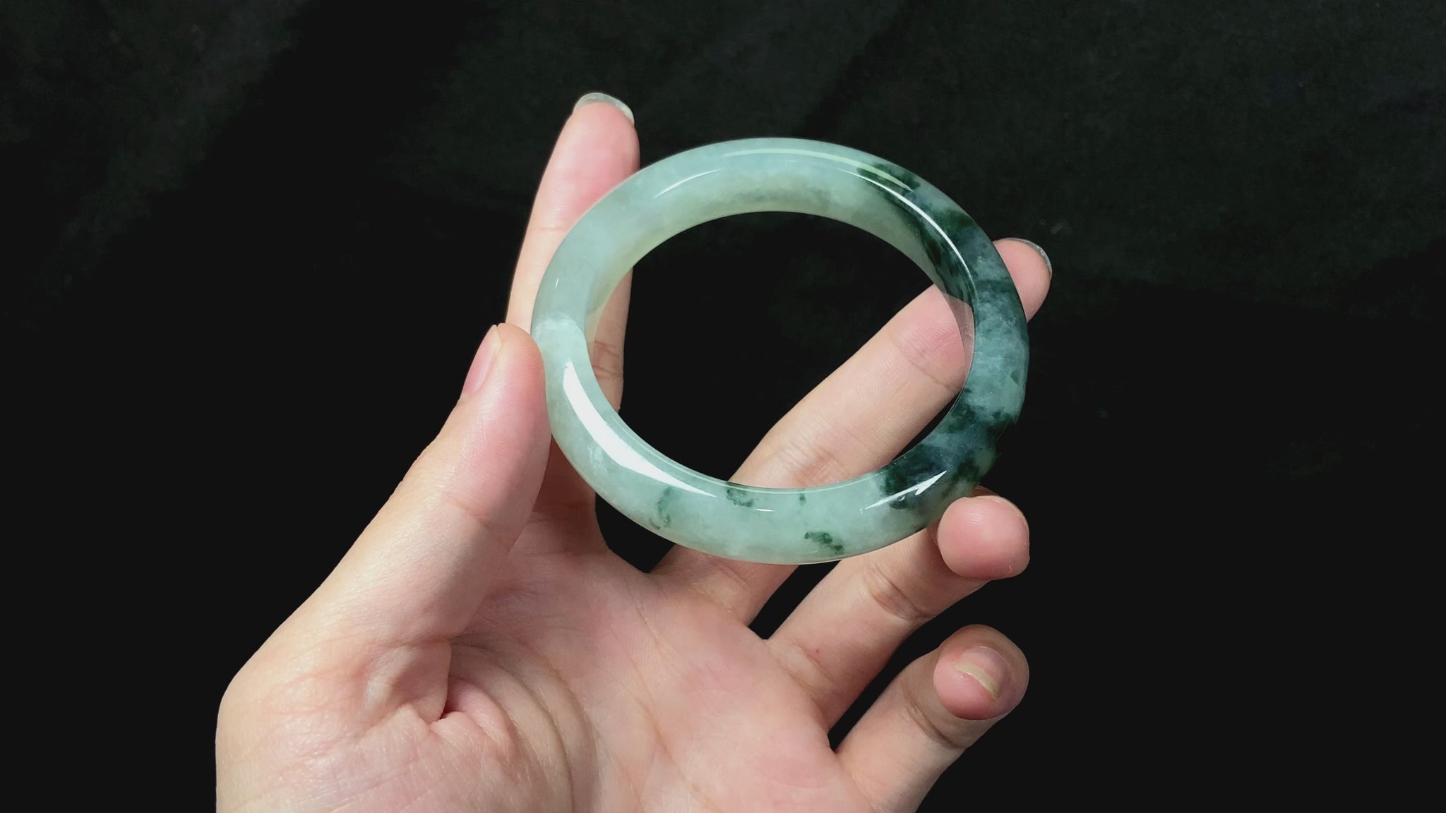 A moss green icy bloom jadeite bangle.