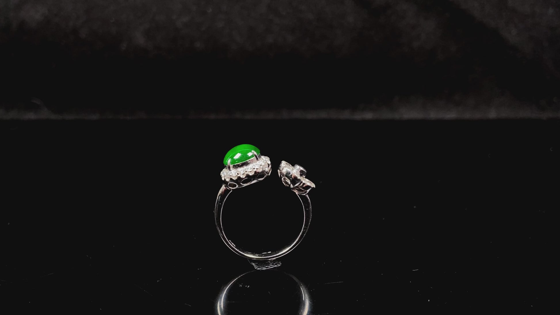 A vivid imperial green halo jadeite ring.