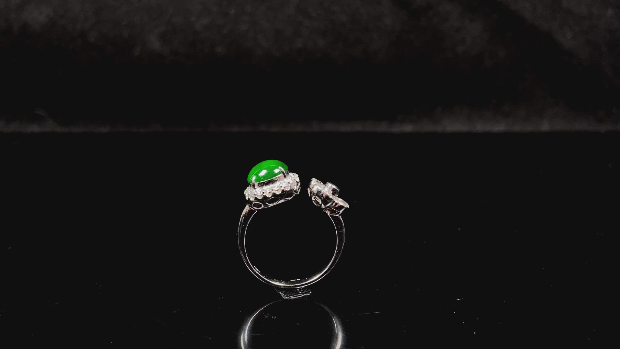 A vivid imperial green halo jadeite ring.