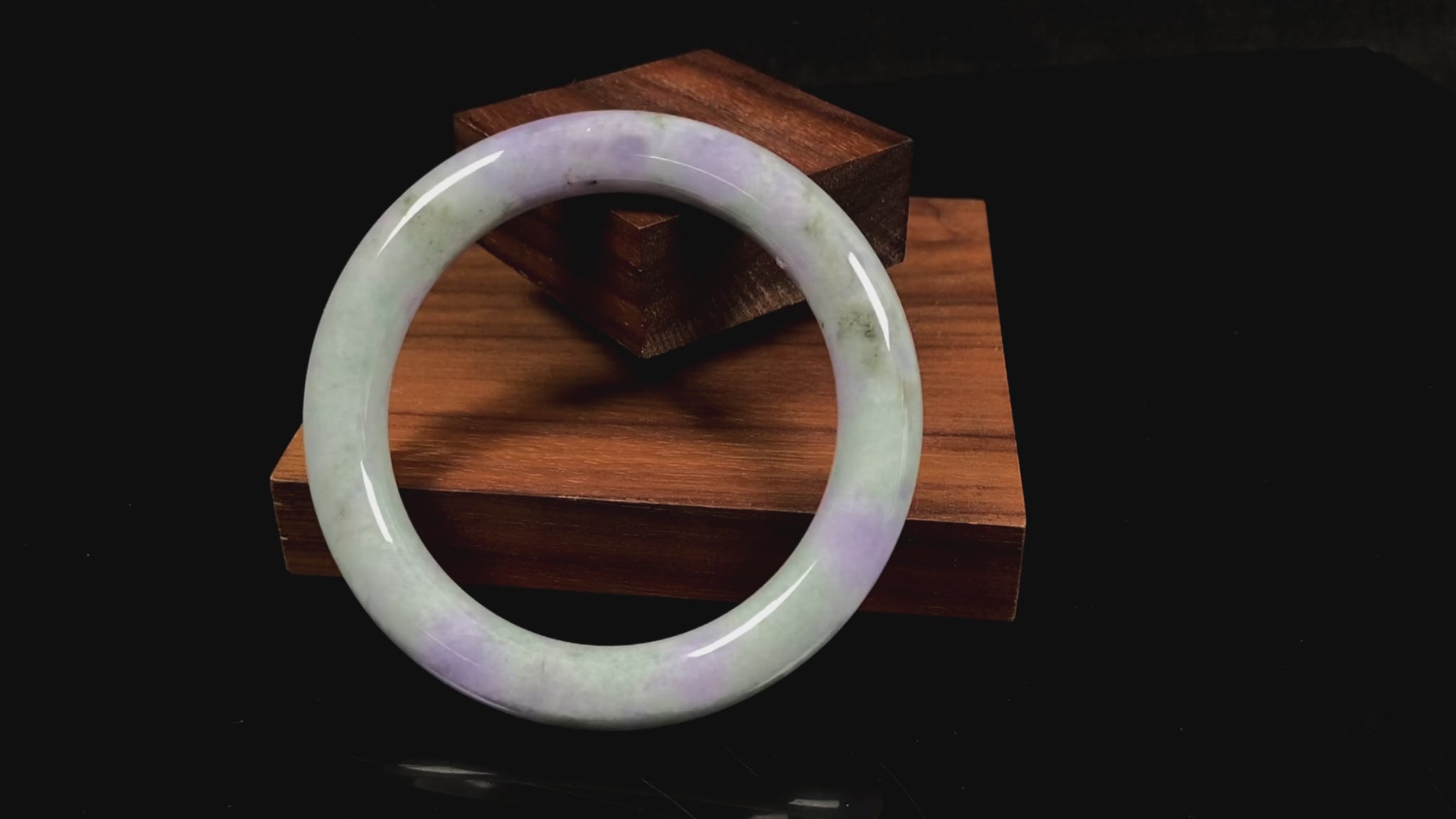 A intermingled green and lavender purple jadeite bangle.