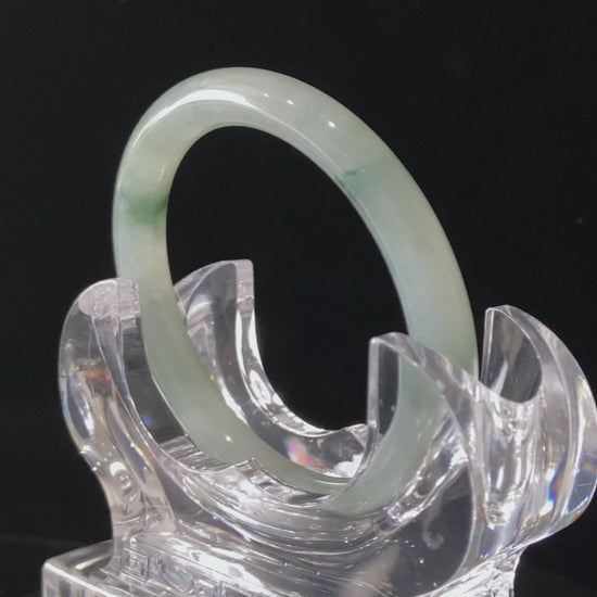 A floating blue ink jadeite bangle.