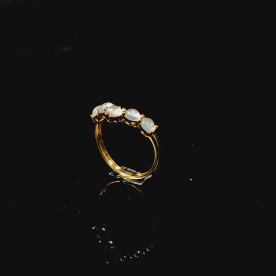 A clear bead cluster crown on gold jadeite ring.