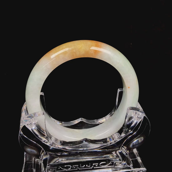 A light fernery gilded mist jadeite bangle.