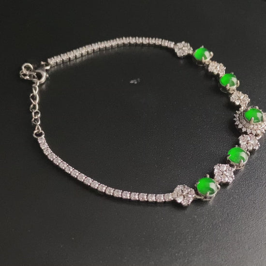 A green sunburst halo jadeite bracelet.
