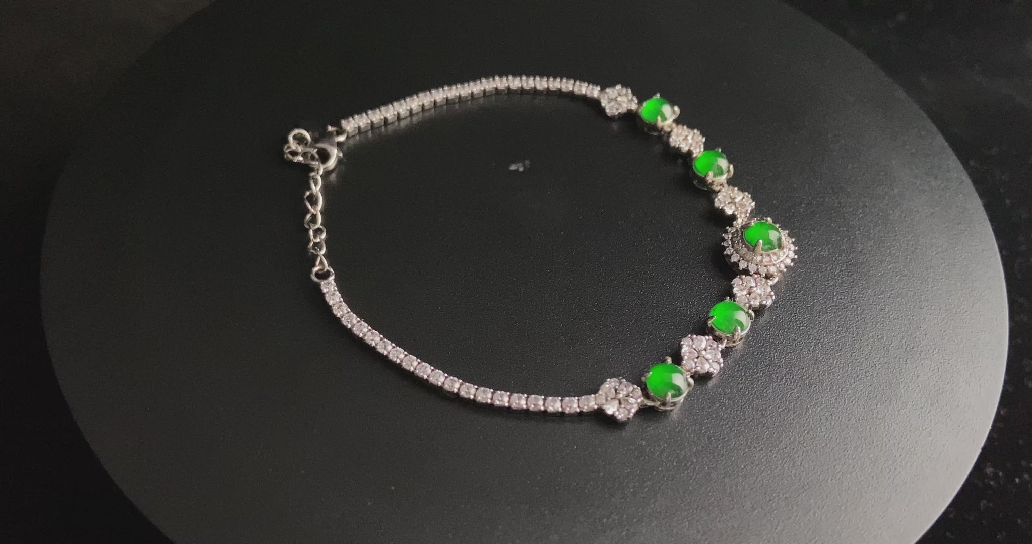 A green sunburst halo jadeite bracelet.