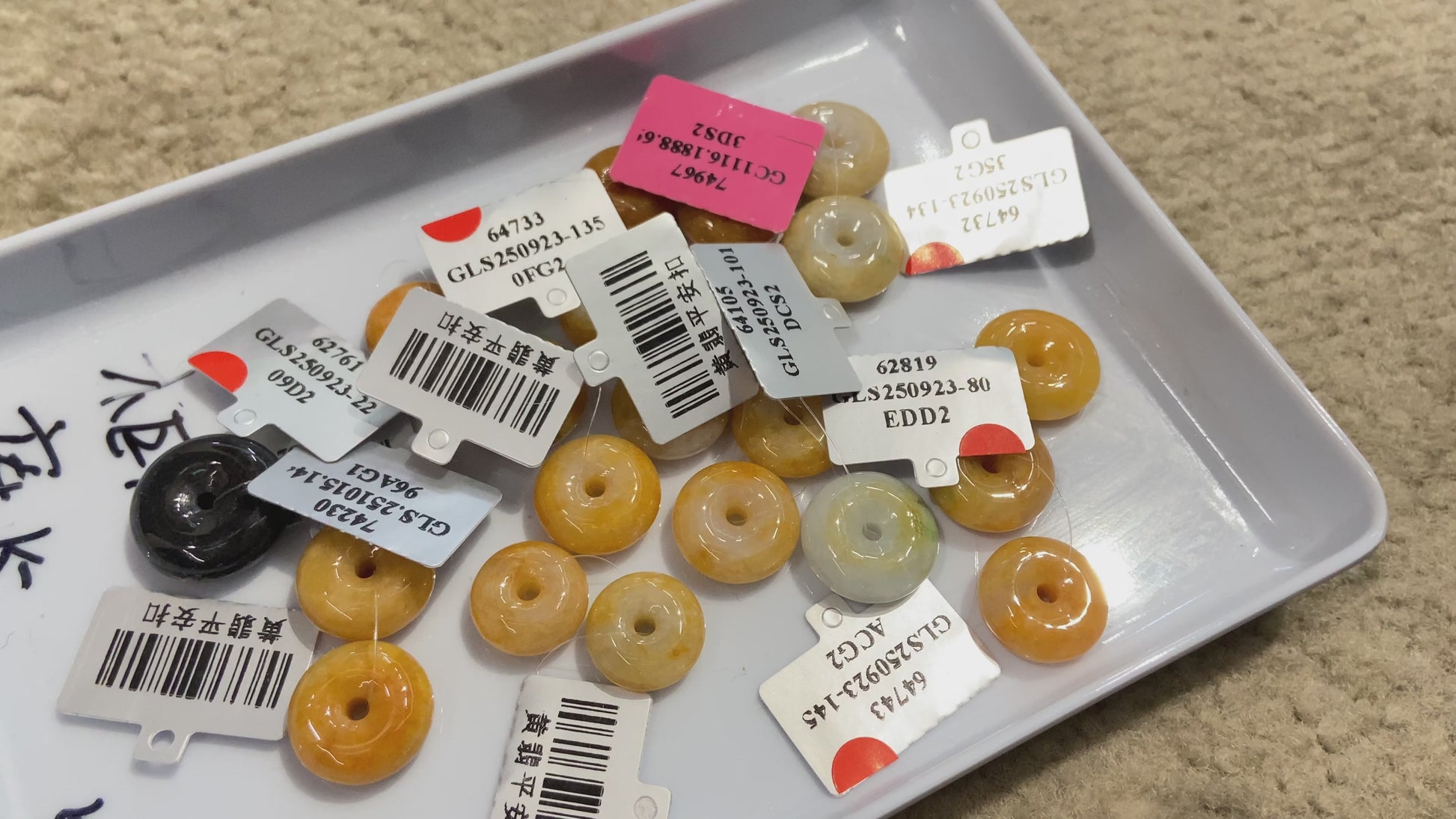 A warm honey hued dual peace buckles jadeite pendant.