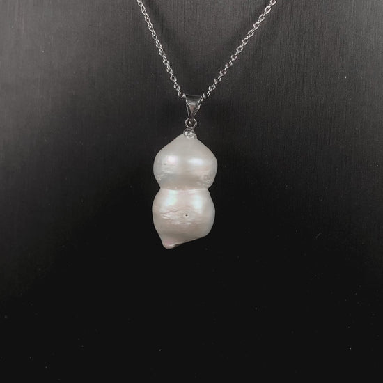 A milky white with blush overtones lucky gourd silhouette pearl pendant.