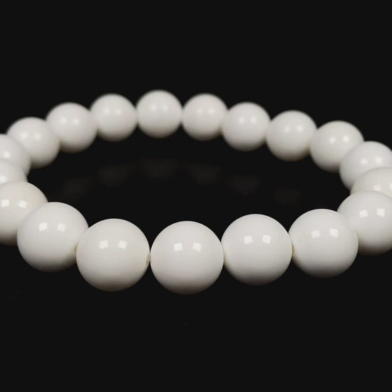 A porcelain white smooth bead ceramic beaded bracelet.