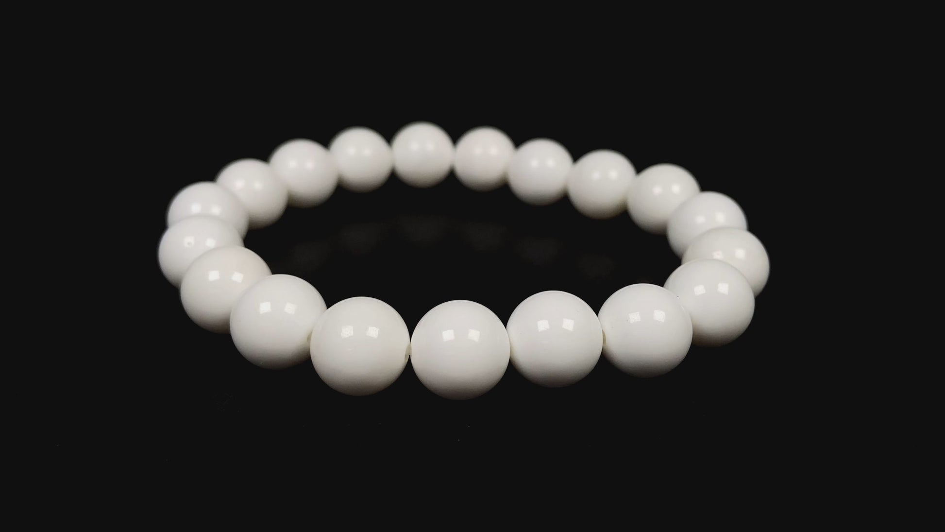 A porcelain white smooth bead ceramic beaded bracelet.