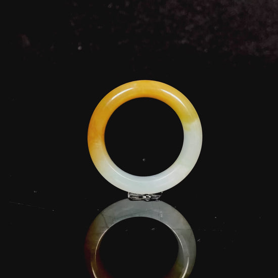 A gradient golden to milky jadeite ring.