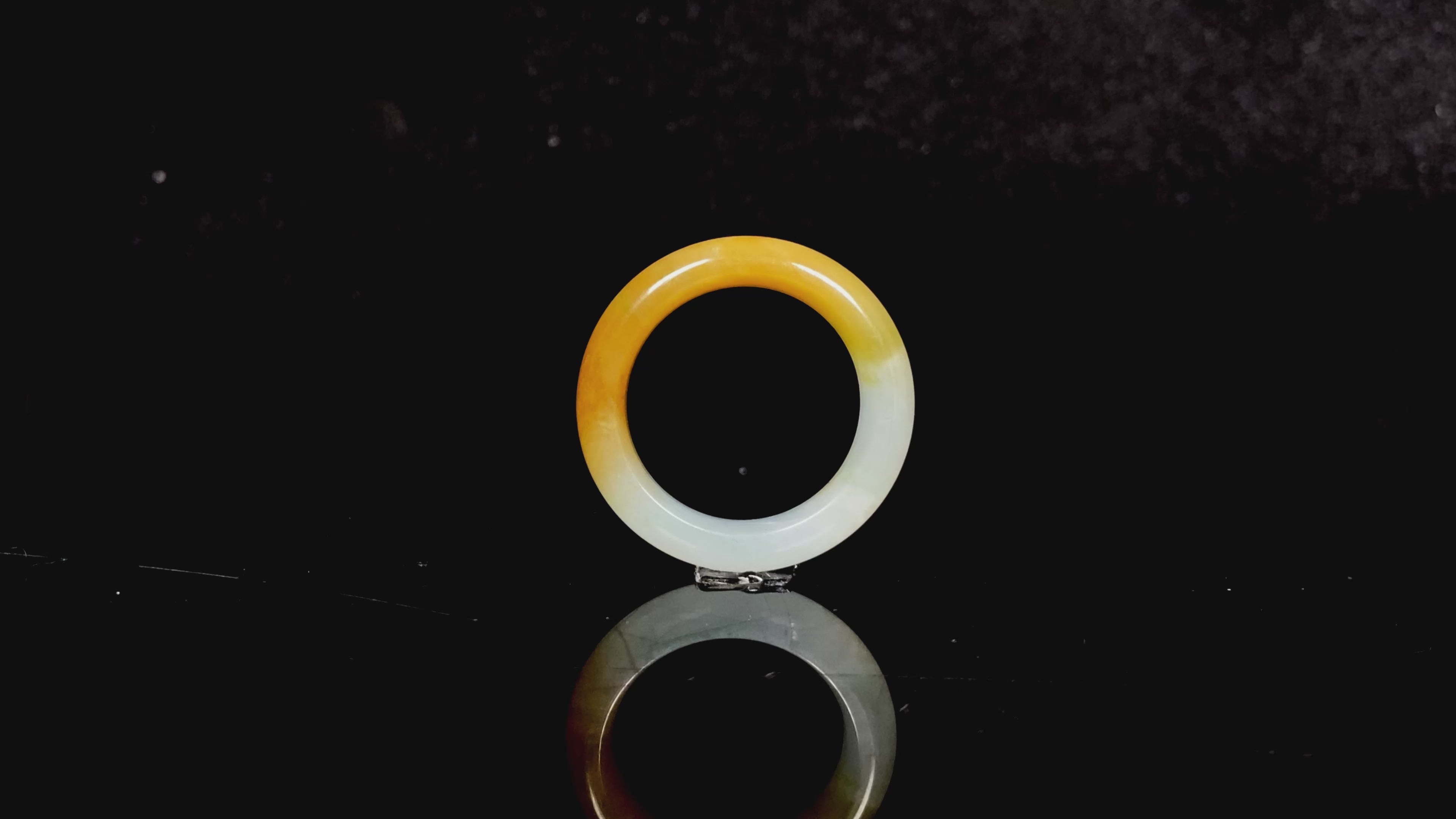 Load video: A gradient golden to milky jadeite ring.