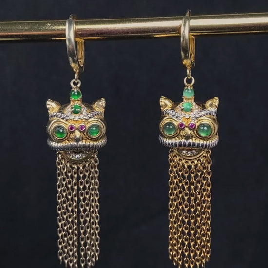 A golden Foo Dog green accent jadeite earrings.