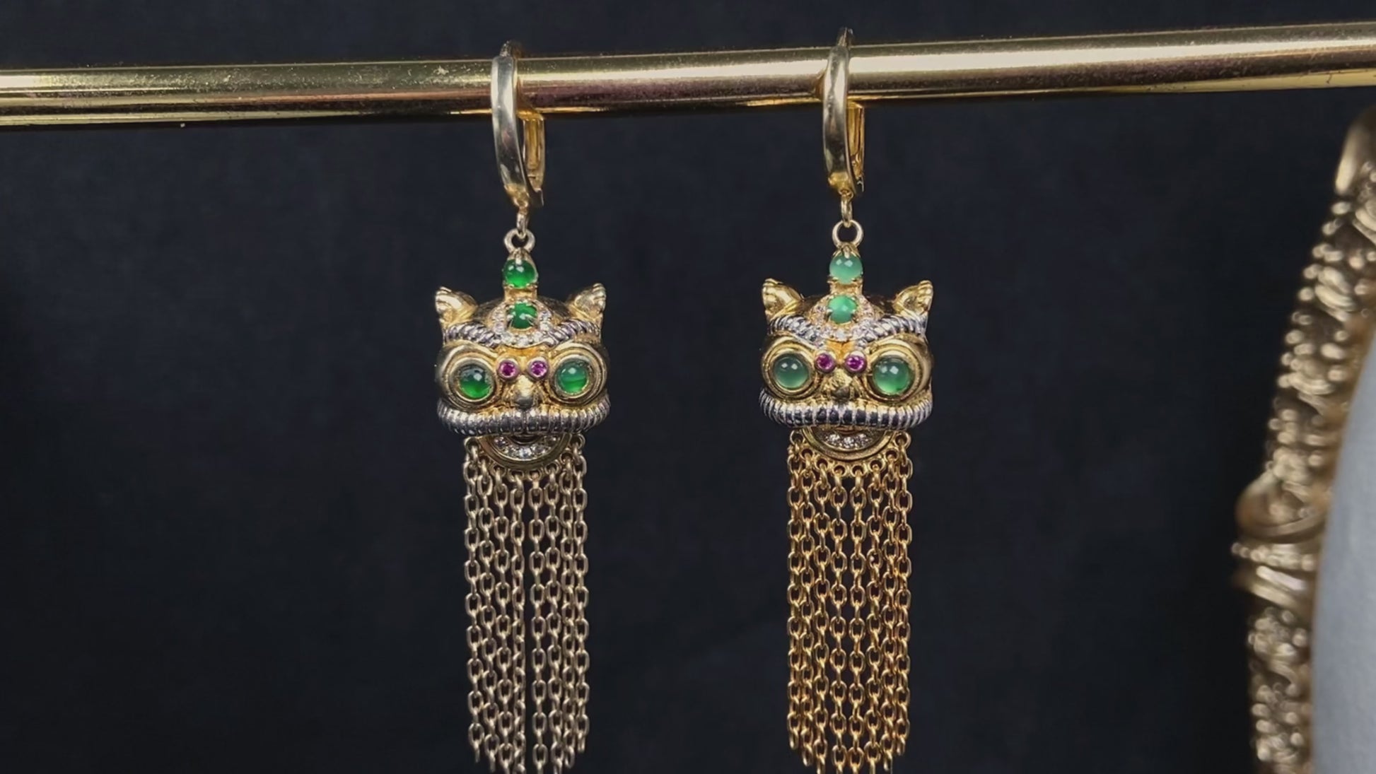 A golden Foo Dog green accent jadeite earrings.