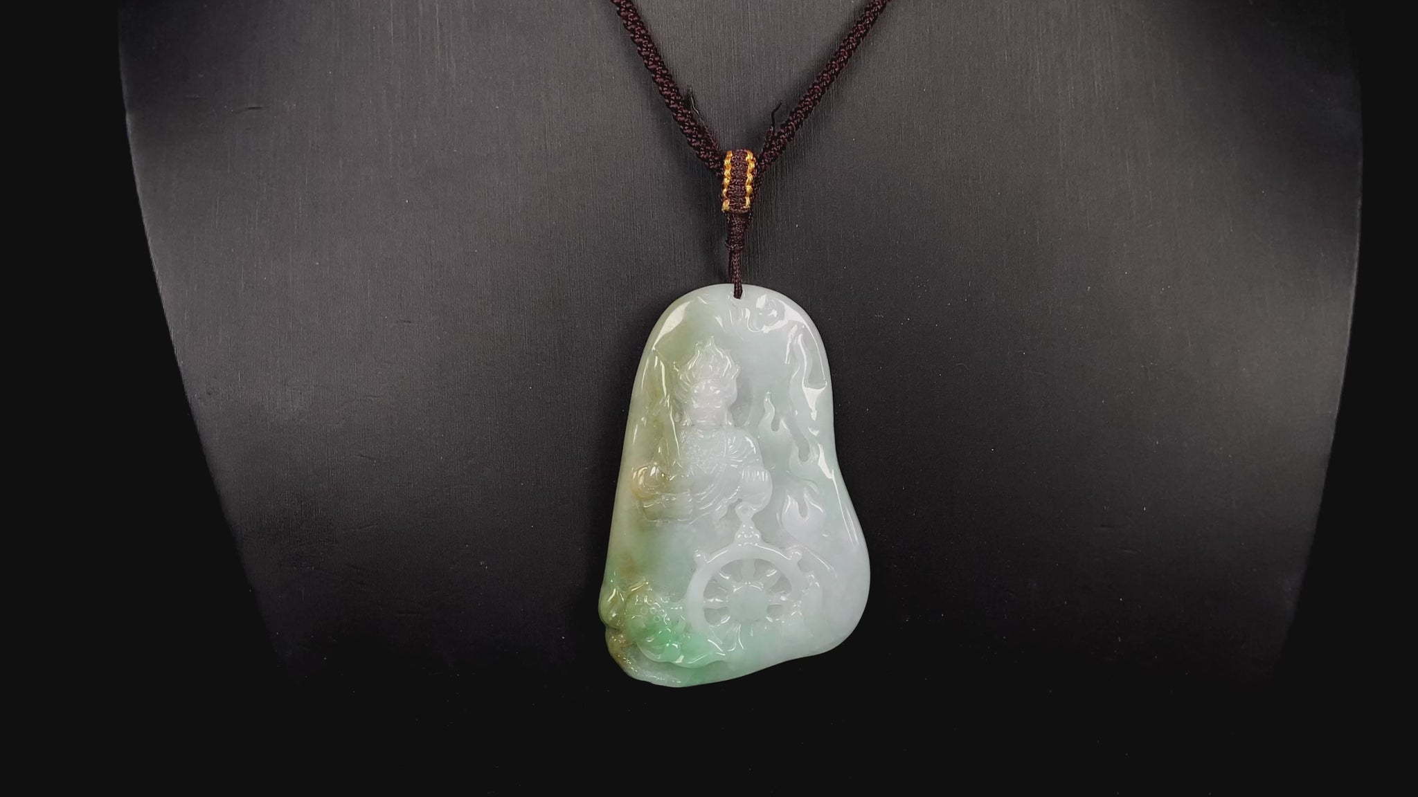 A green-yellow bodhisattva with dharma wheel jadeite pendant.