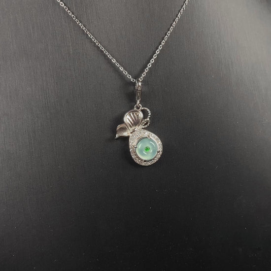 A icy green wealth pouch jadeite pendant.