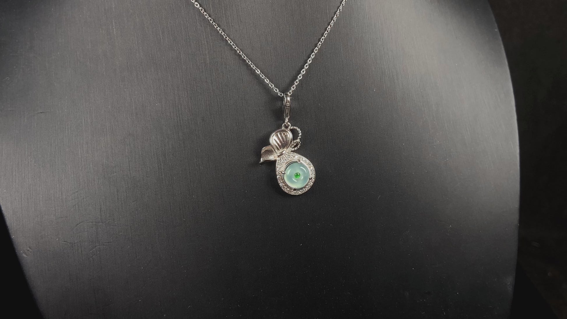 A icy green wealth pouch jadeite pendant.