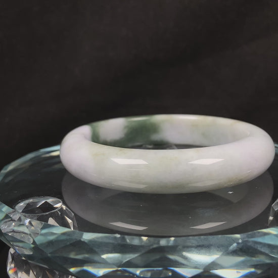 A creamy white green  jadeite bangle.