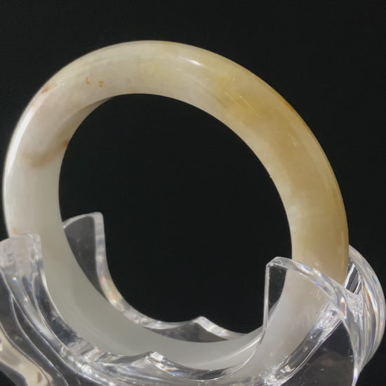A golden honey veil jadeite bangle.