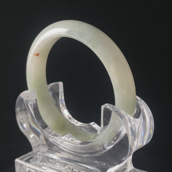 A milky mint honey spot jadeite bangle.
