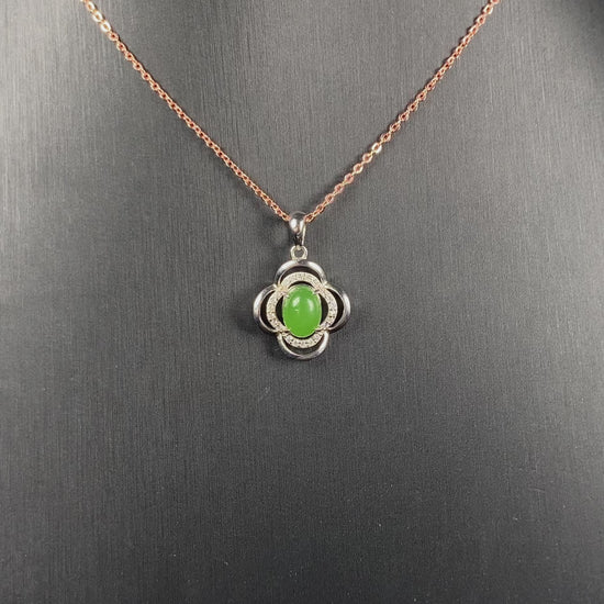 A vibrant clover green cabochon Hetian jade pendant.