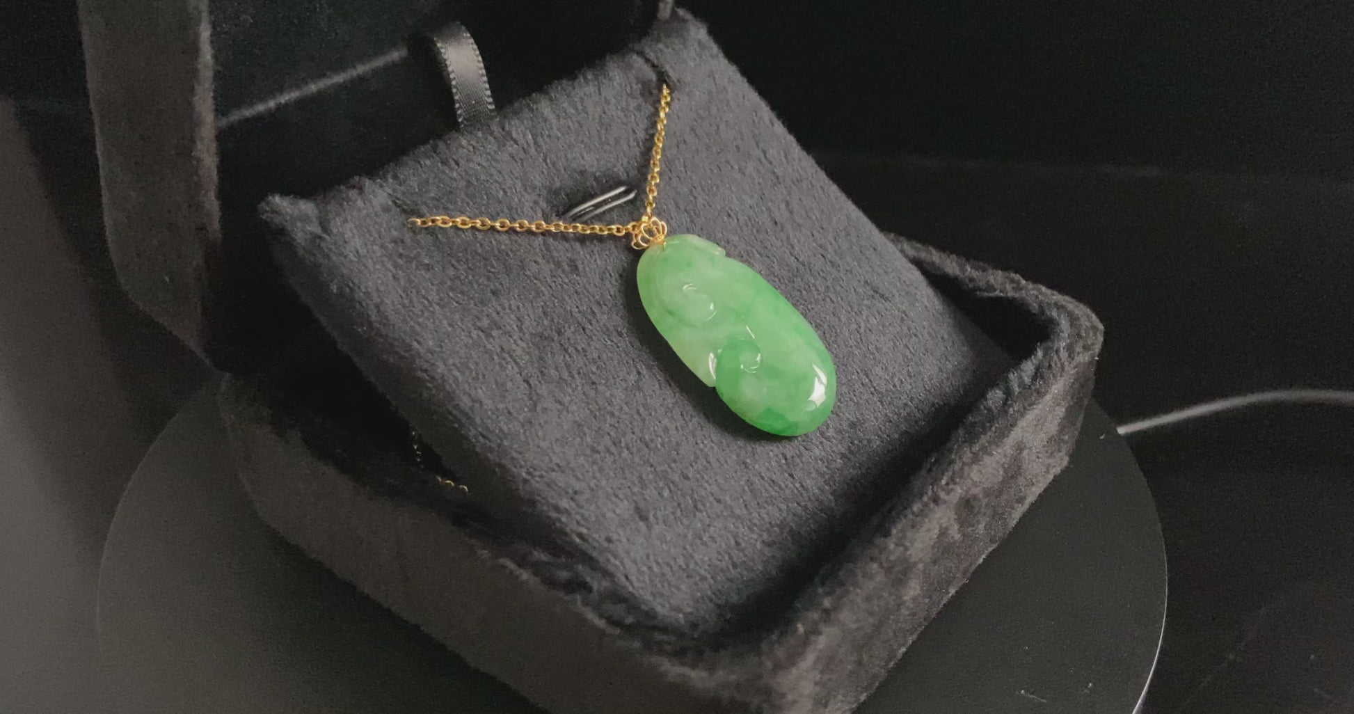 A foat green Ruyi jadeite pendant.