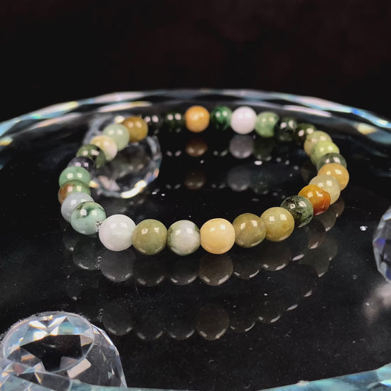 A  jadeite beaded bracelets is made of mixed green, yellow, gray and black beads.