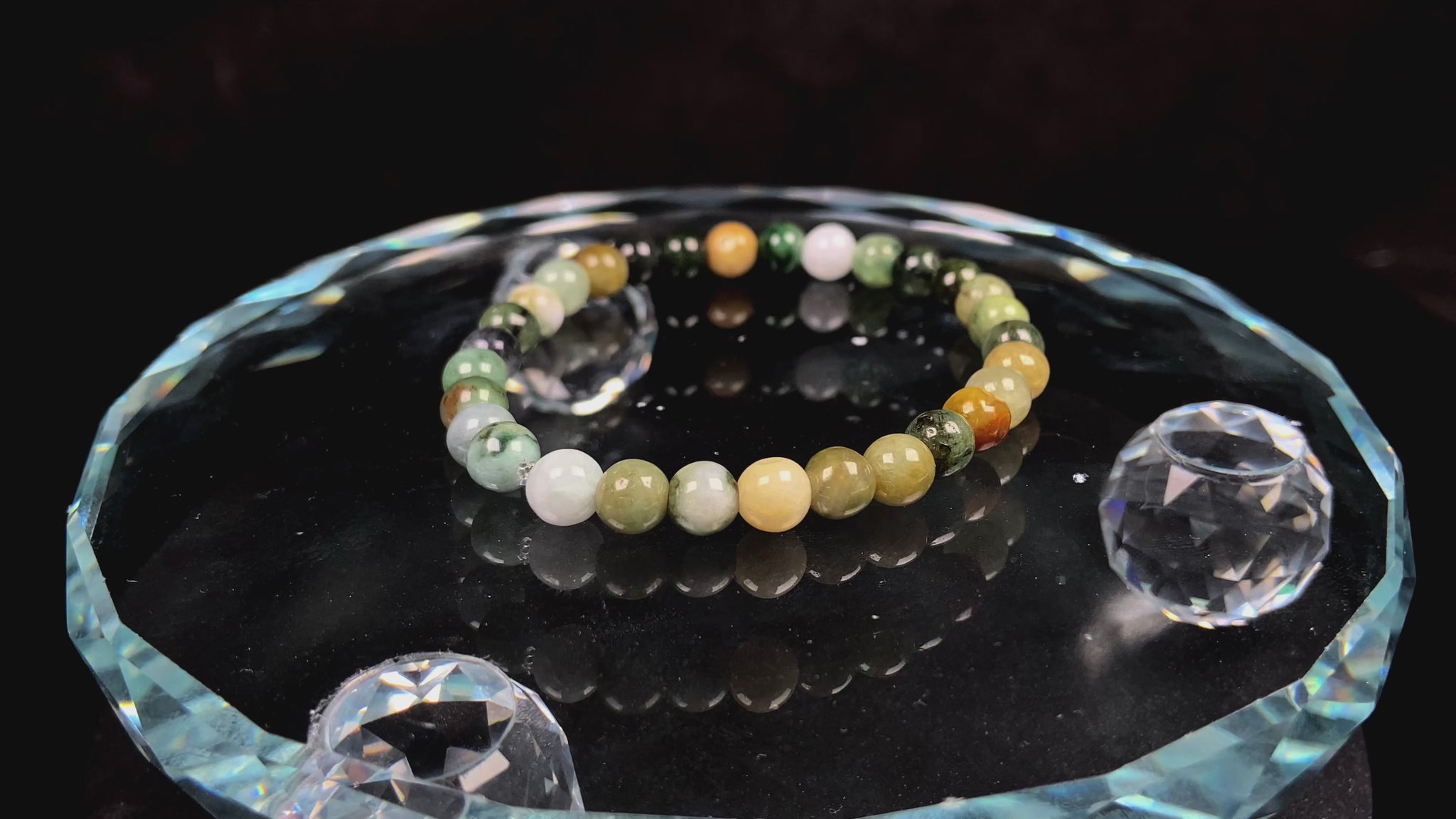 A  jadeite beaded bracelets is made of mixed green, yellow, gray and black beads.