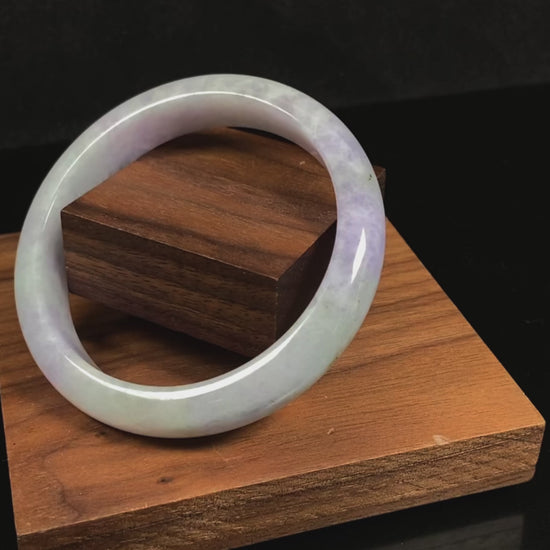 A milky green white base with soft lavender veins jadeite bangle.