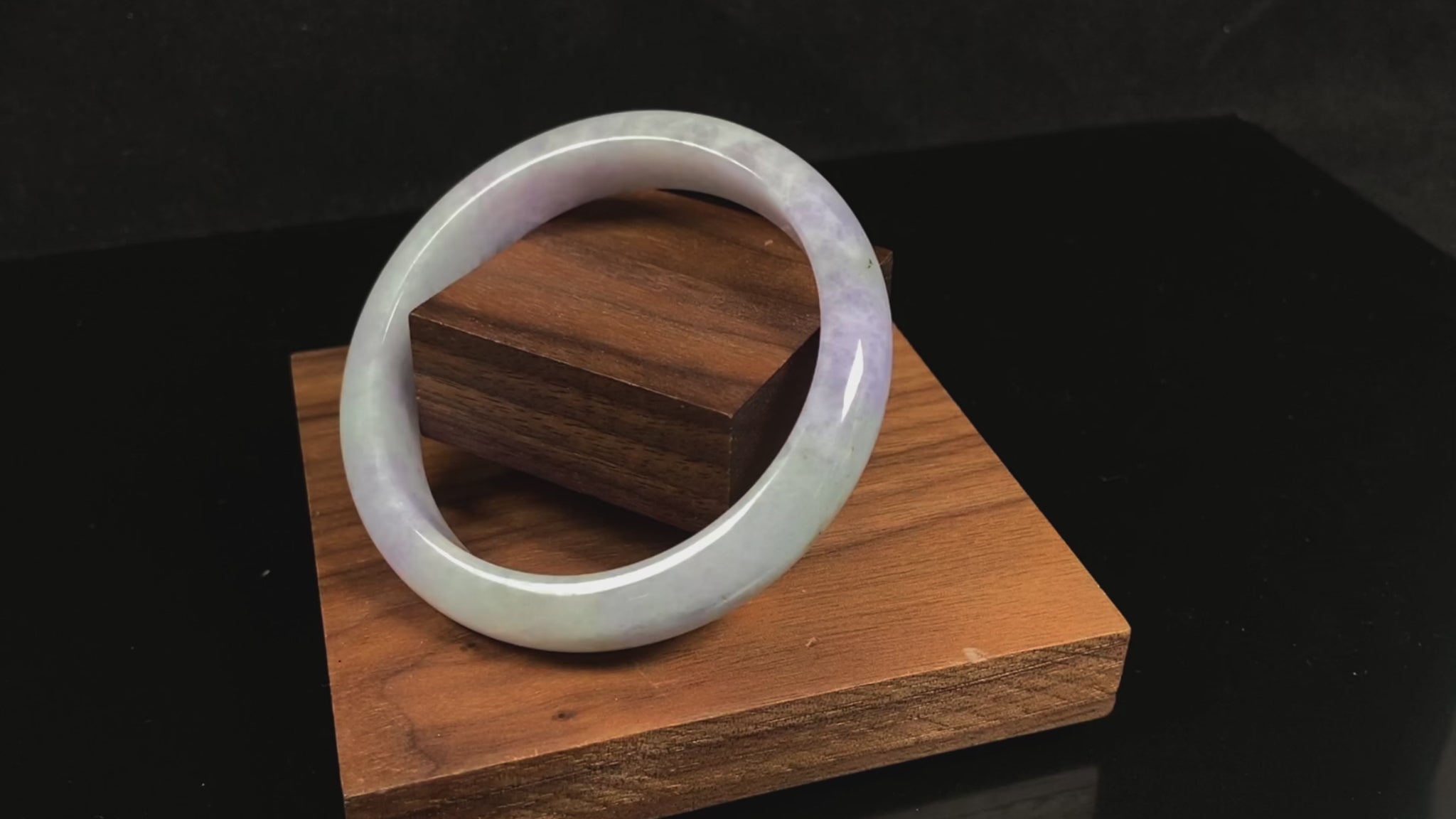 A milky green white base with soft lavender veins jadeite bangle.