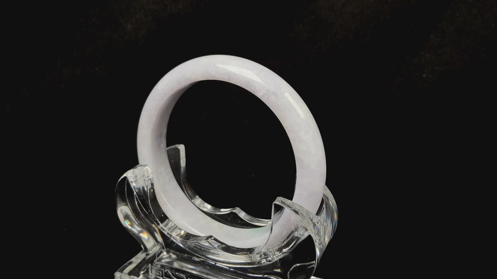 A cloudy white with pale green streaks jadeite bangle.