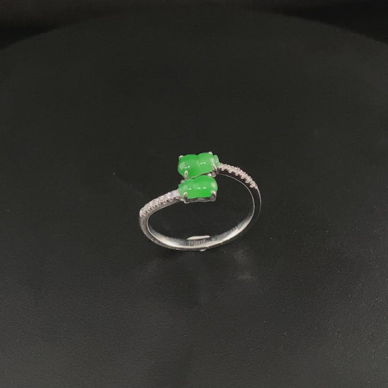 A bright green double gourd jadeite ring.