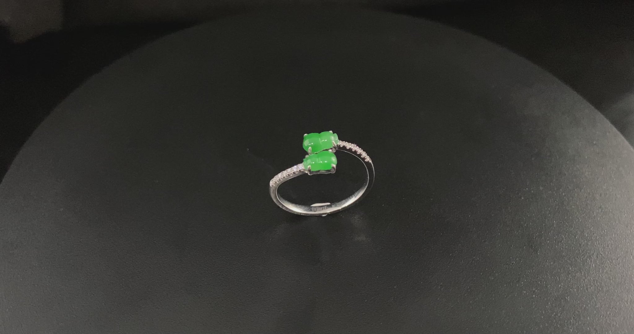 A bright green double gourd jadeite ring.