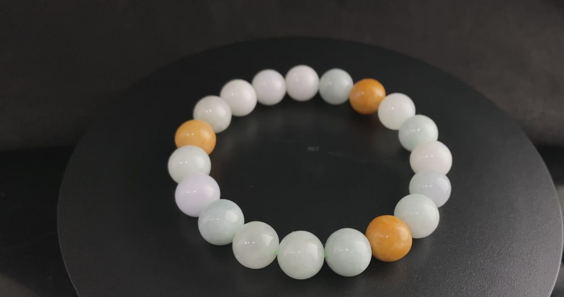 A four hues harmony jadeite beads bracelet.