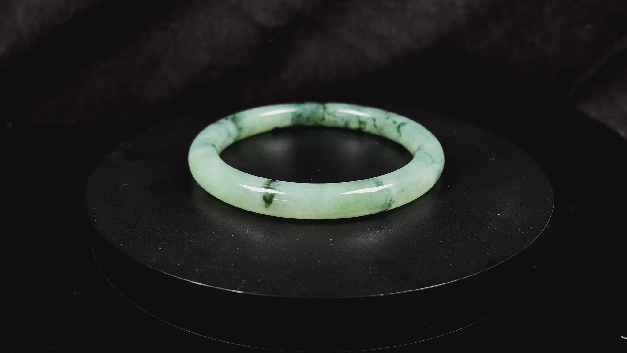 A waxy icy with moss green jadeite bangle.