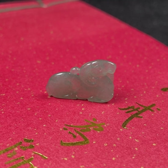 A lustrous pale green sheep loose jadeite.