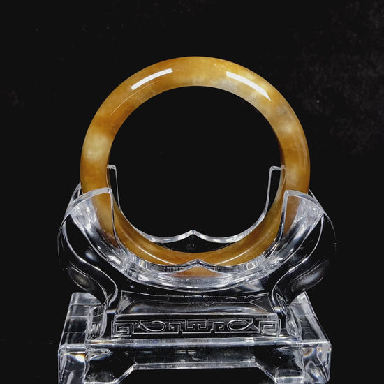 A ambered wisp luster jadeite bangle.