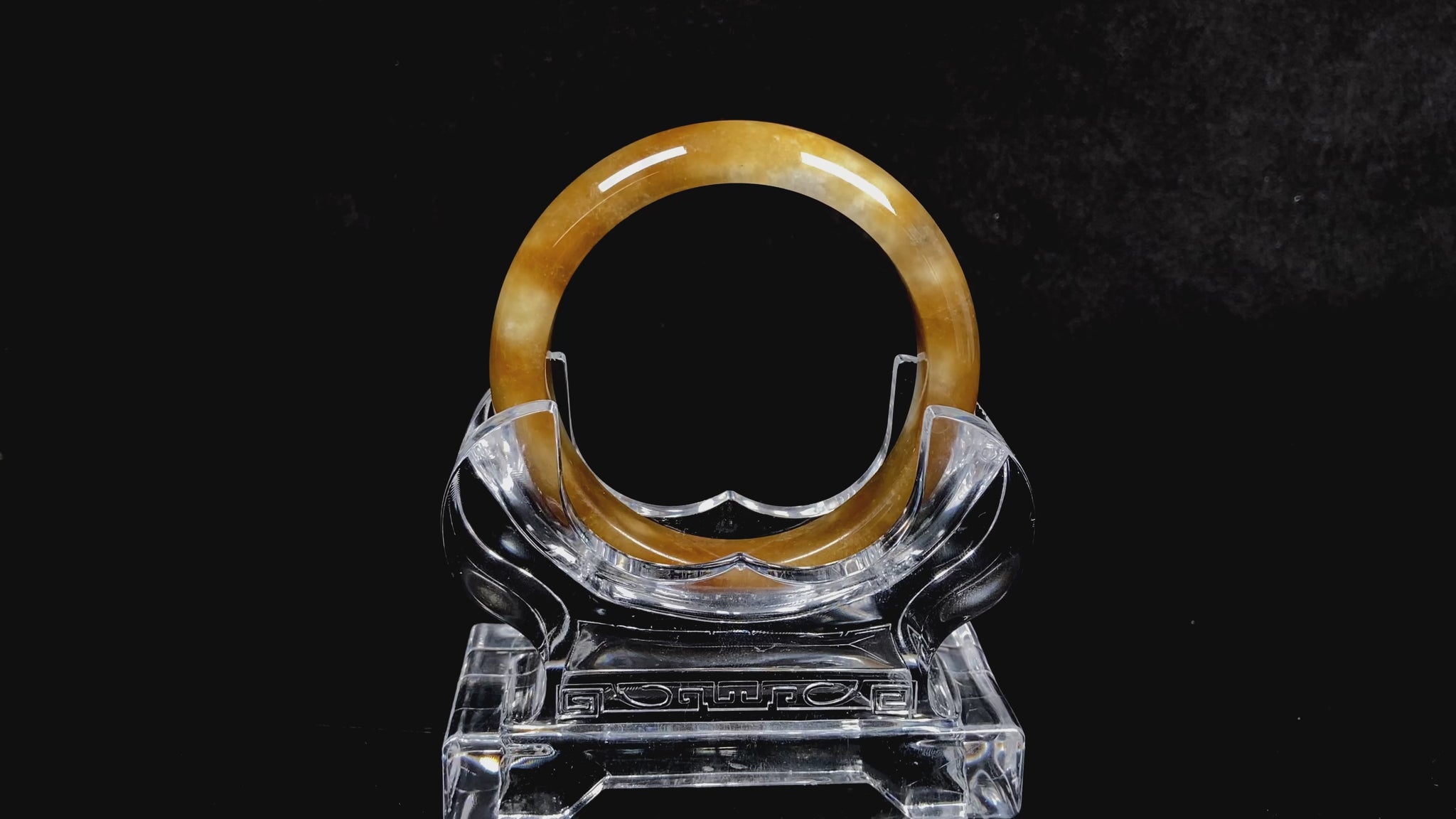 A ambered wisp luster jadeite bangle.