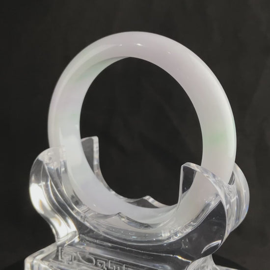 A pristine white with green veil jadeite bangle.