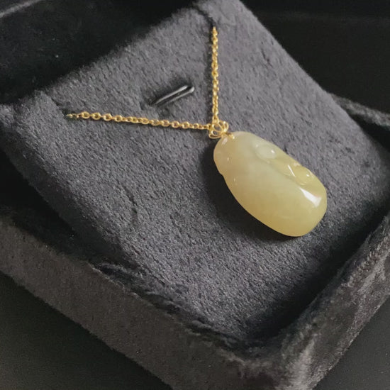 A creamy yellow Ruyi jadeite pendant.