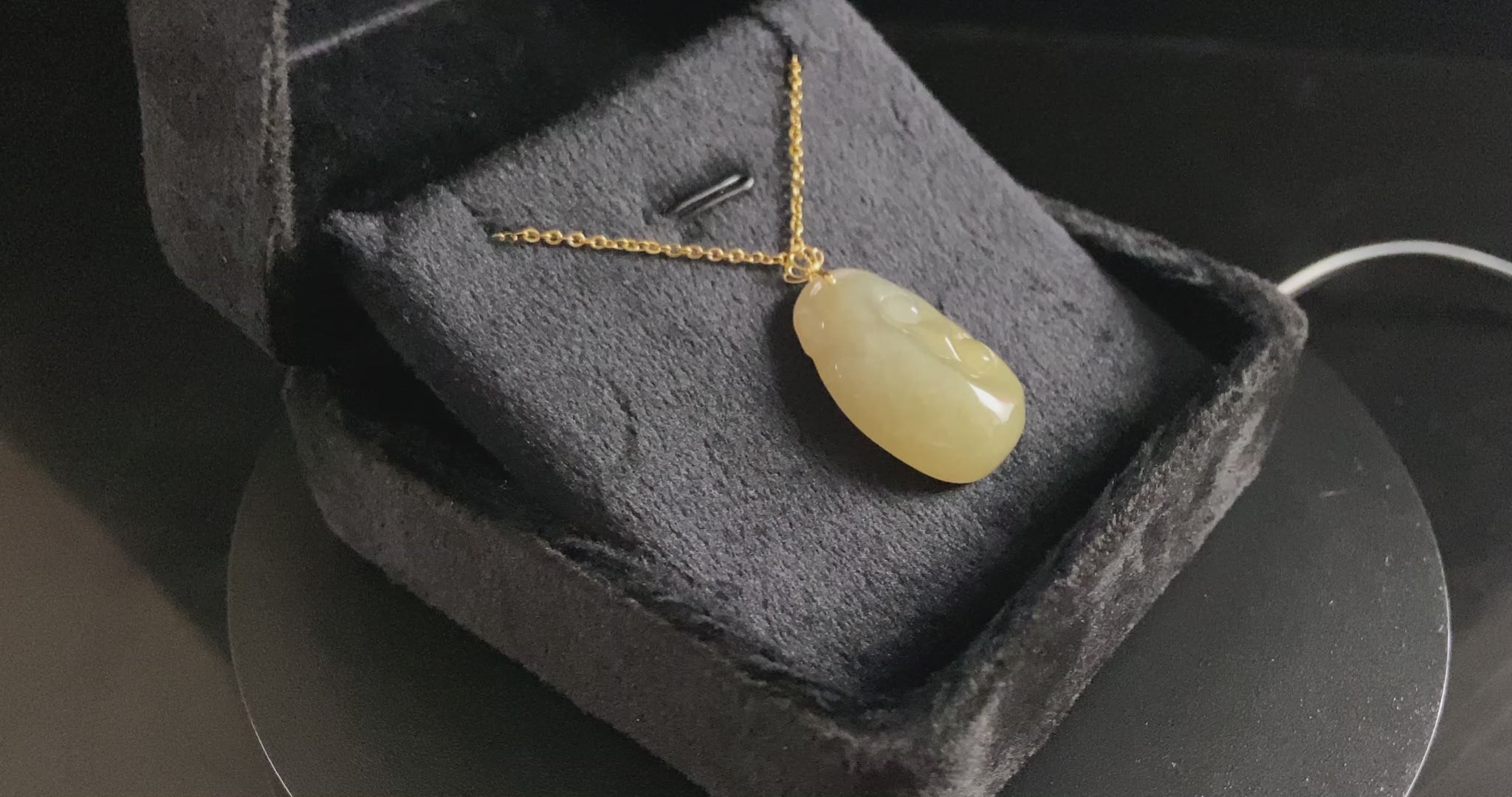A creamy yellow Ruyi jadeite pendant.