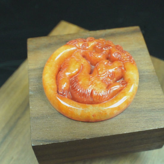 A glowing orange red dog loose jadeite.