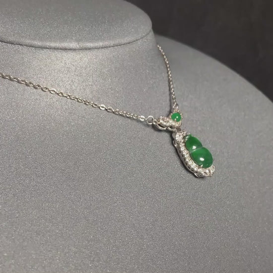 A glossy green lucky gourd jadeite pendant.