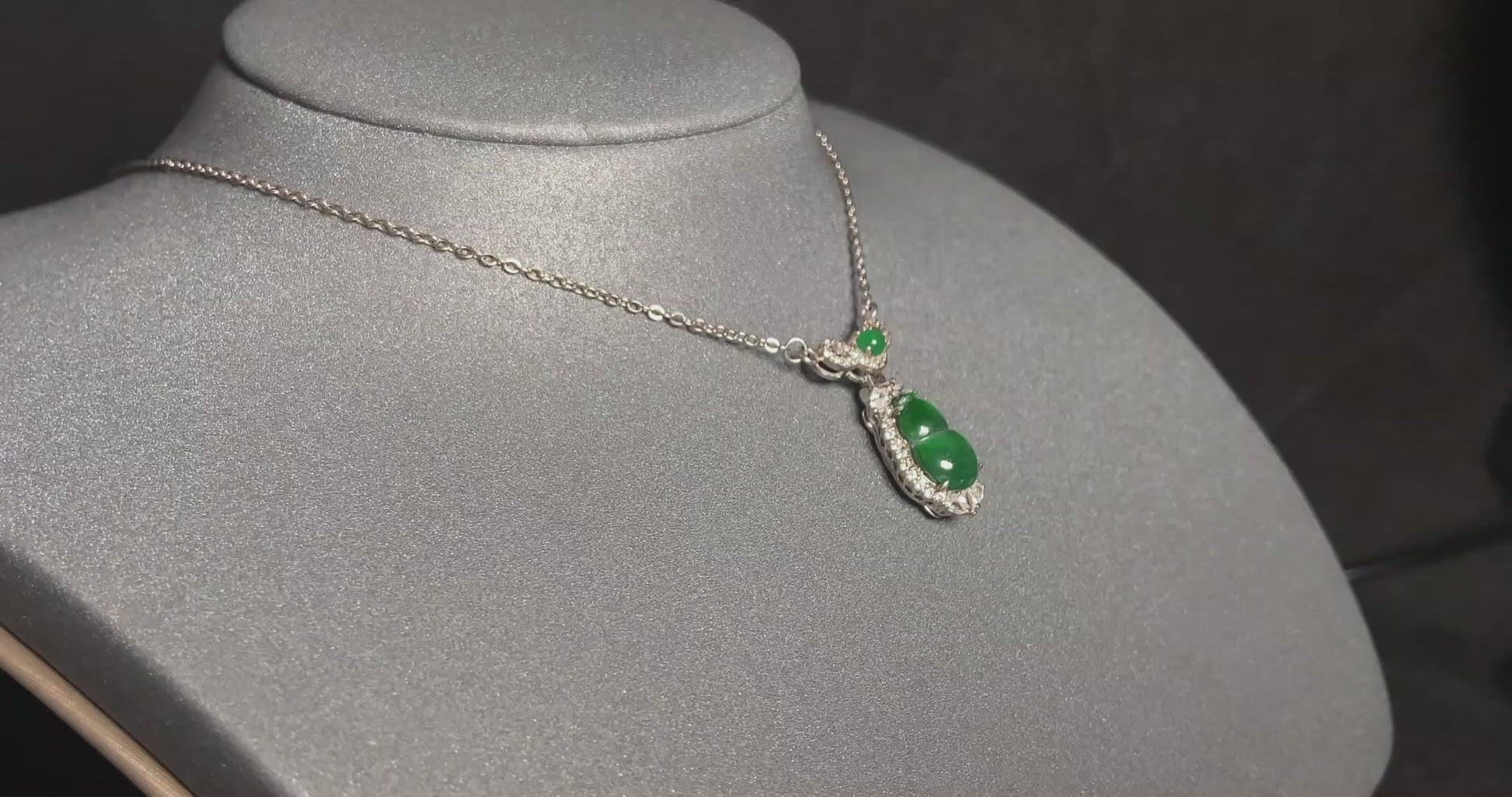A glossy green lucky gourd jadeite pendant.